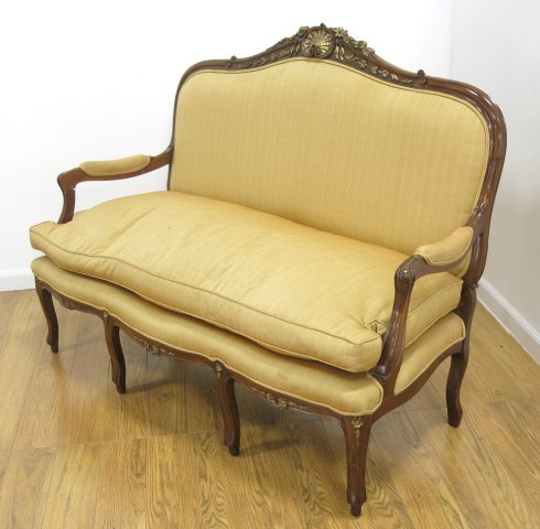 Carved Walnut French Style Loveseat: With gilded floral accents. Approx. 41 1/2" H x 55" W. From an estate in Great Neck, NY.