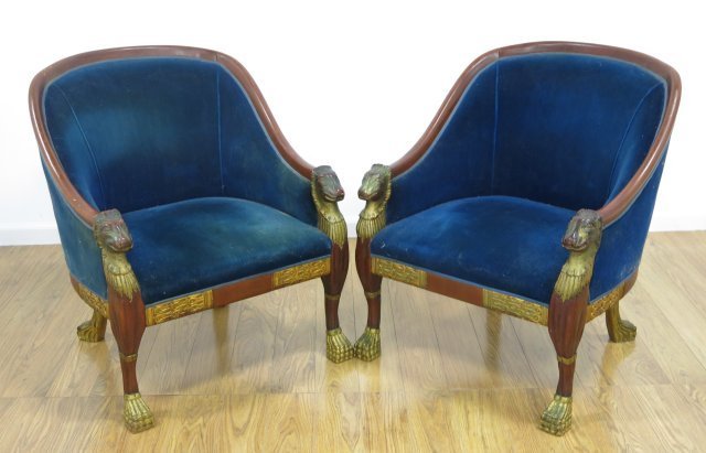 Pair Empire style Parcel Gilt Mahogany Bergeres: Approx. 34" H x 24" W x 28" D. Gilding slightly worn. Upholstery stained.