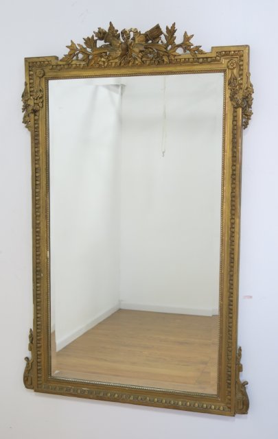 Gilt Carved Mirror: Gesso & wood. Birds & foliate design. Approx. 68 1/2" H x 42" W. Old repair on top.