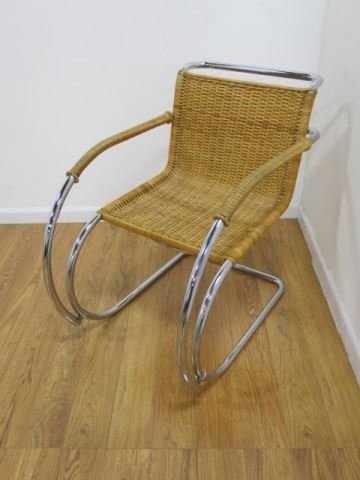 1970's Chrome & Caned Back Rocking Chair: From the Estate of Mrs. Barry Martin. Approx. 31" H x 22" W x 28" D.