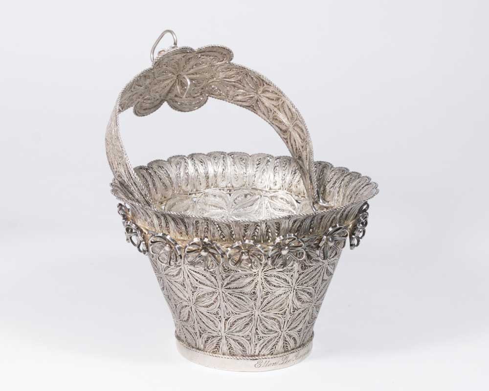 Spanish Colonial Silver Basket: With swivel handle. Filigree design. Dated 1915. Approx. 9 1/2" H with handle up x 6" D. Approx. 24.56 ozt, 776.4 g. From the 40-year personal collection of a retiring antique dealer.