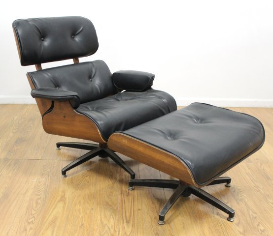 Plycraft Walnut Swivel Armchair & Ottoman: Circa 1970. Upholstered in black leatherette. Chair approx. 34 3/4" H x 33 1/4" W x 34" D. Ottoman approx. 16" H x 26" W x 21" D.