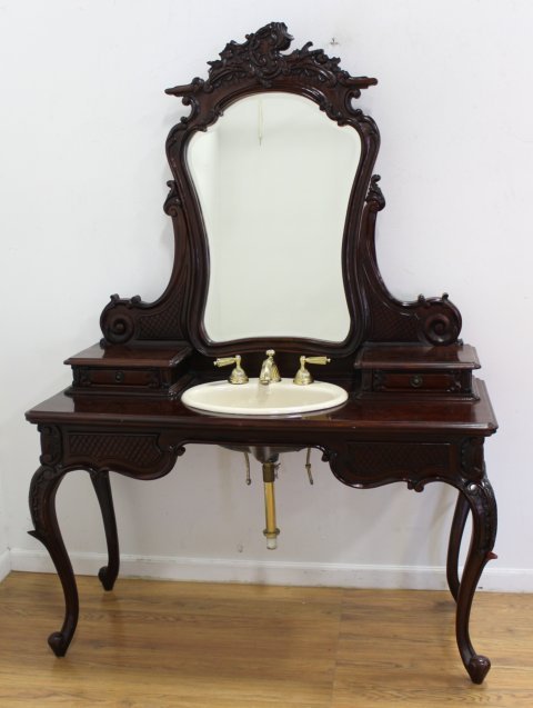 French Style Vanity Sink: Mahogany. Scroll design with Kohler sink. With swivel mirror. Height of mirror approx. 72" x 51" W x 21" D.