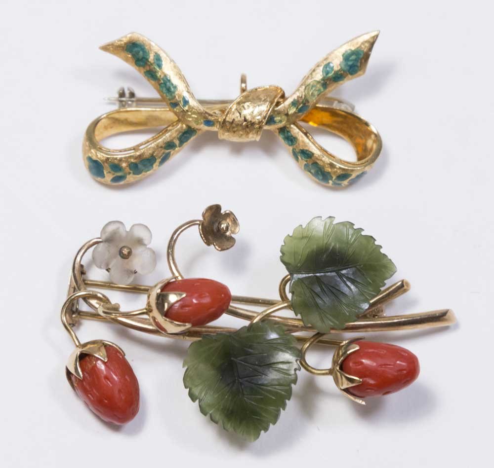 2-18K Yellow Gold Pins: Includes 1 green enamel bowknot design; and jade and coral floral pin. Approx. 12.5 dwt. From a Fort Lee, NJ estate. Coral floral pin missing one stone.