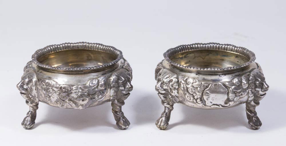 Pair Sterling Silver Master Salts: 19th century English. Charles Stuart Harris. Hallmarked for 1890 London. Decorated with 3 lion heads with paw feet. Approx. 2" H x 3 3/4" W. Total weight approx. 14.5 ozt, 453.4 grams. From the estate