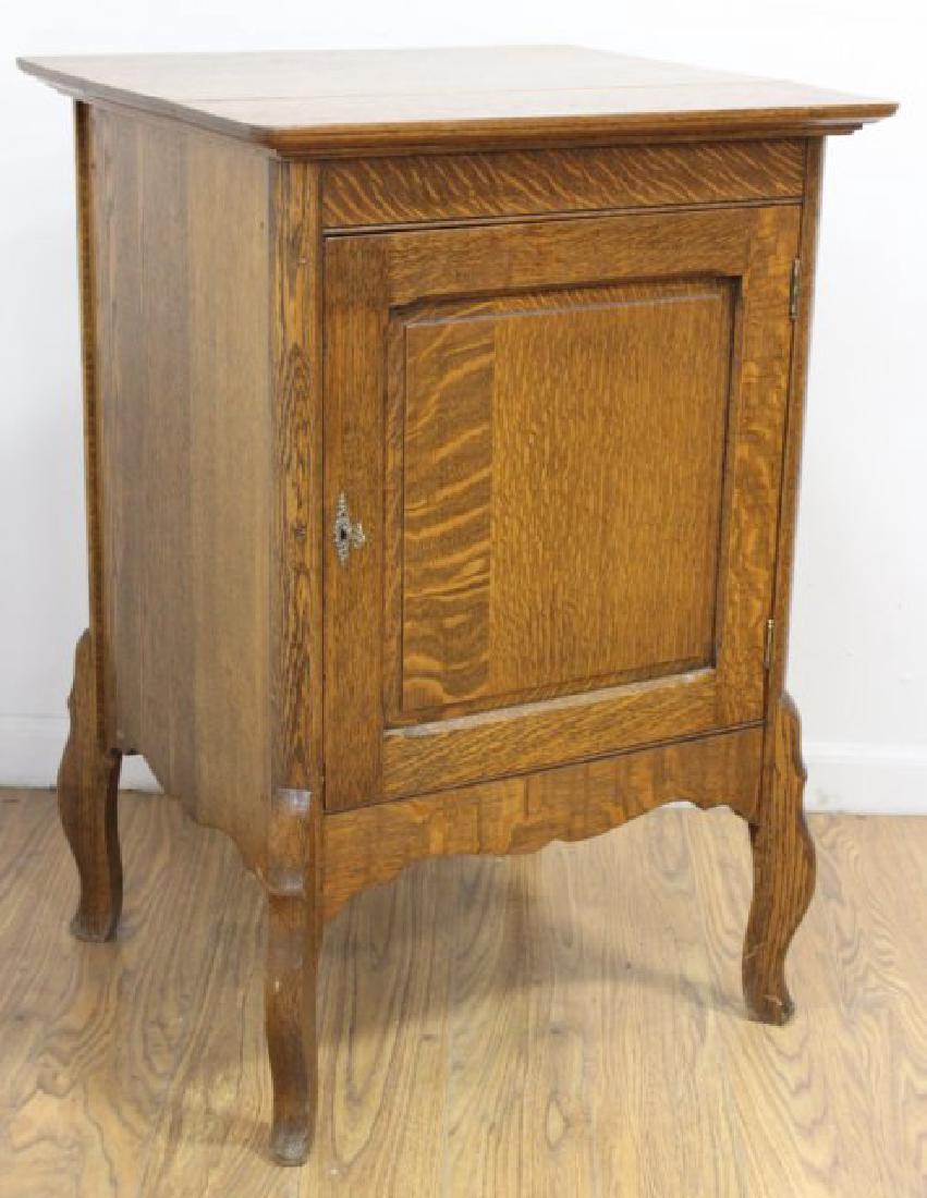 Oak Disc Cabinet: Cabriole legs. Key lock. Slots for discs. Approx. 33 1/2" H x 23" W x 21" D.