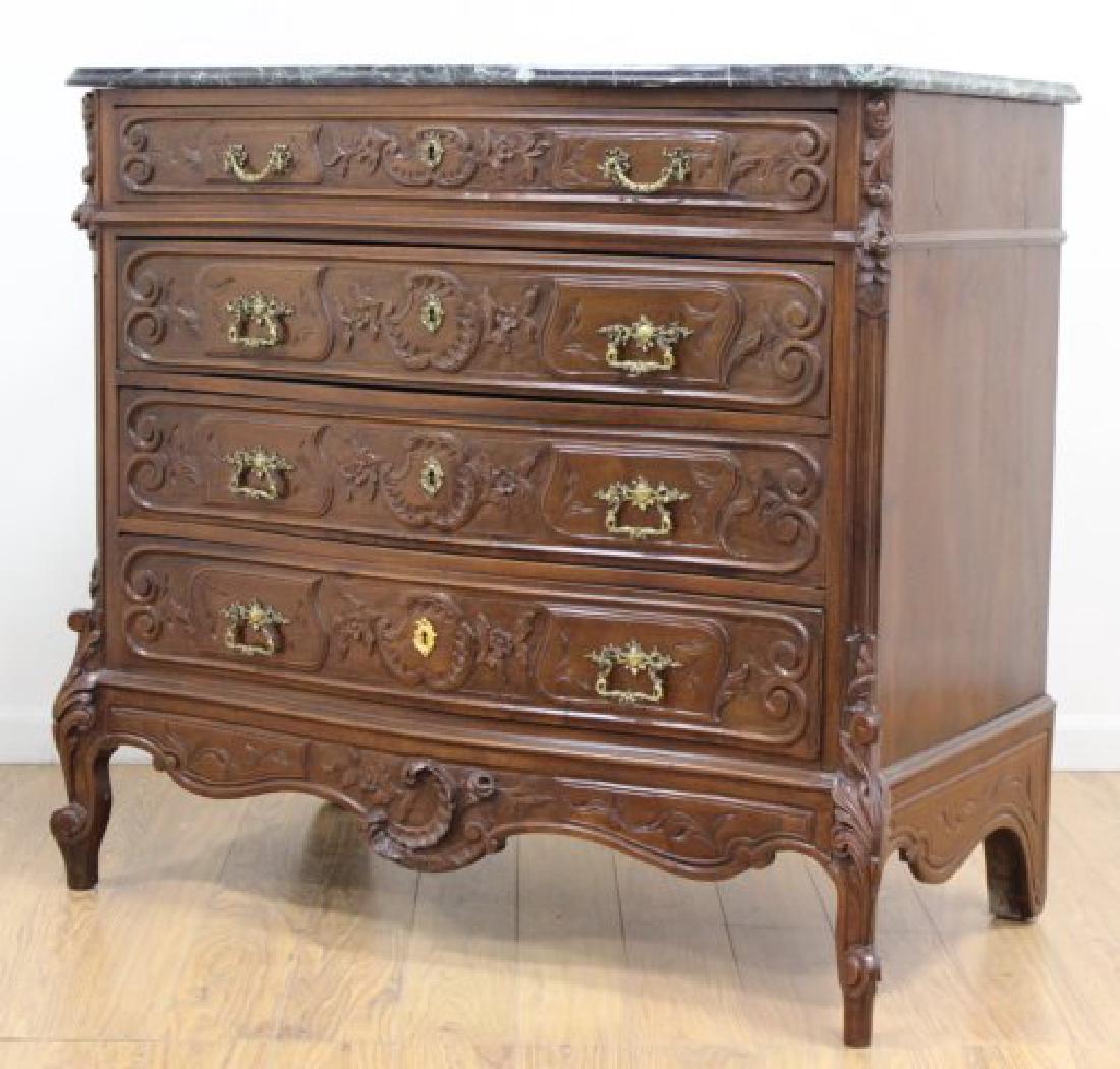 Black Marble Top Carved Commode: 20th century. 4 drawers. Beveled marble top. Approx. 40" H x 43" W x 22" D.