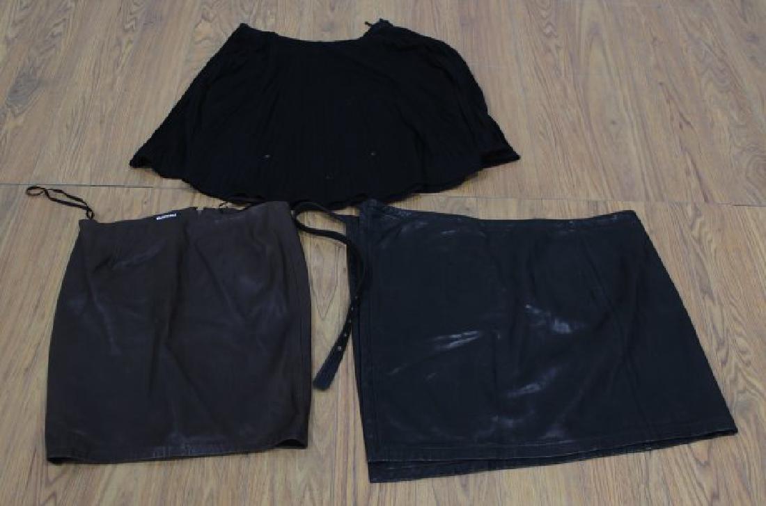 3 Designer Skirts: Including DKNY brown 100% leather mini skirt; Isaac Mizrahi black leather wrap skirt with buckle closure, size L; and Gianni Versace black wool solid knee length pleated skirt, size 46. DKNY skirt in