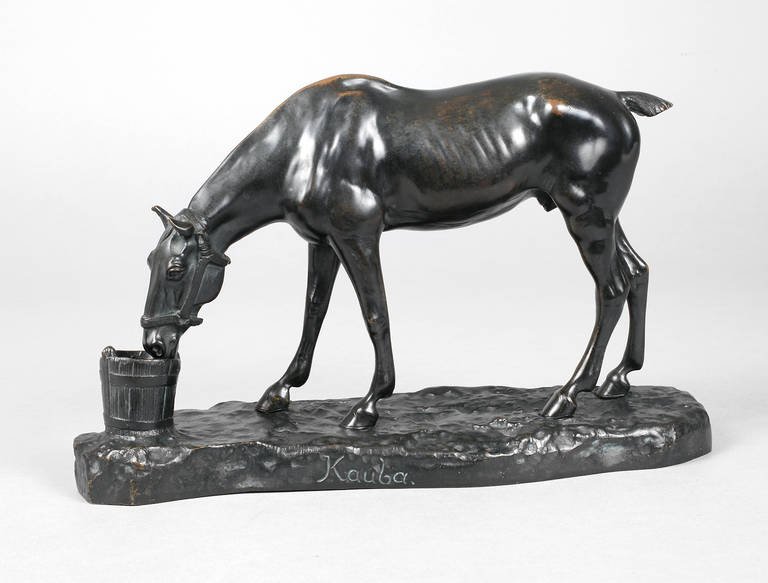 Carl Kauba, Pferdeplastik: um 1900, seitl. an der Plinthe sign. Kauba, Bronze schwarz patiniert, vollplastische Darstellung eines aus einem Kübel fressenden Wallachs mit gestutzter Mähne und Schweif, auf naturalistisch gestal