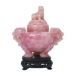 A carved rose quartz censer topped with a foo dog on: A carved rose quartz censer topped with a foo dog on lid and lion head handles