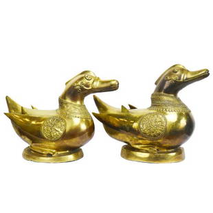 A pair of brass duck figures: A pair of brass duck figures
