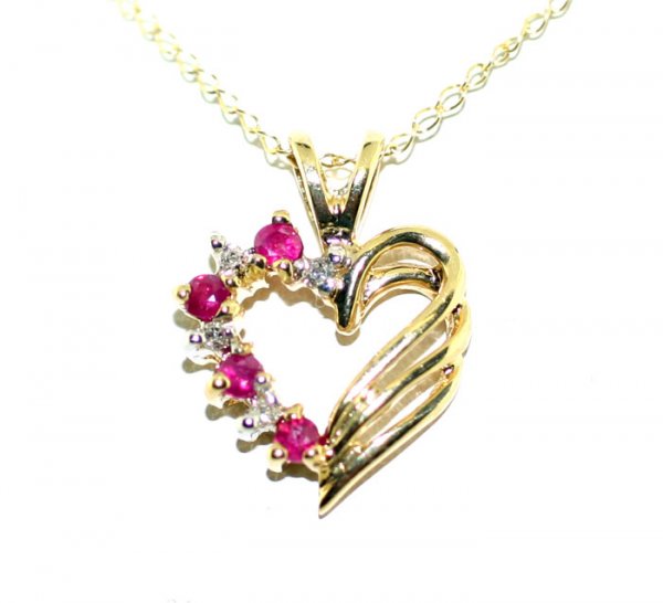 3533: 0.25 CT DIAMOND & RUBY 10K GOLD PENDANT .