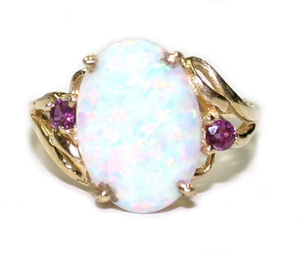 3.CT RUBY & OPAL 10K GOLD RING.: THIS IS A 10 KARAT YELLOW GOLD RING . IT WEIGHS 3.40 GRAMS AND CONTAINS 2 NATURAL ROUND SHAPE RUBY AND AN OVAL SHAPE OPAL 12x10 mm IN THE CENTER . THE RING IS SIZE 7'' .
