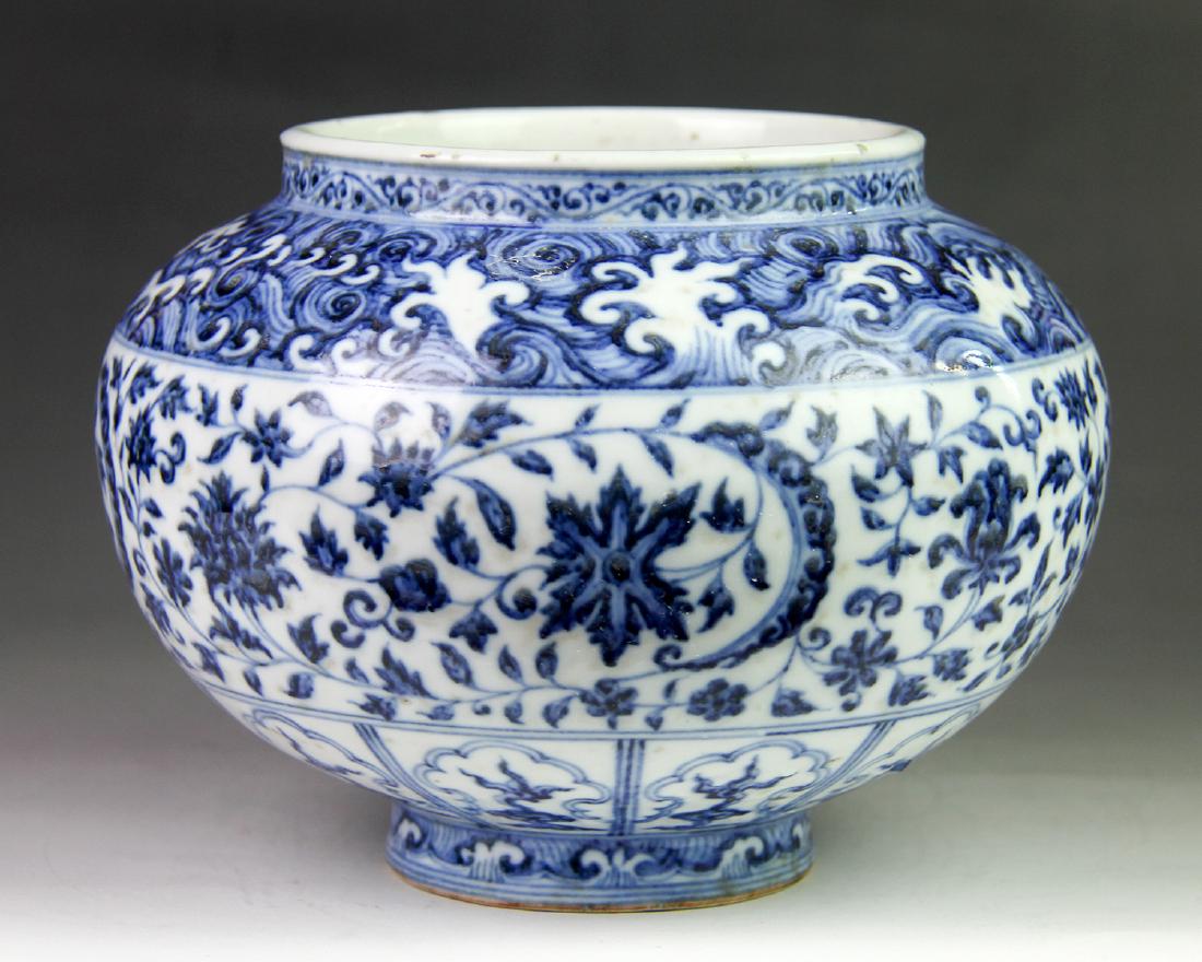 MING YONGLE BLUE&WHITE JAR: Ming YongLe Dynasty. The blue & white jar is painted with floral and leafy scrolls design in blue on the exterior. The shoulder and foot are encircled with a band of wave design. Dimension 6.10 in x 5