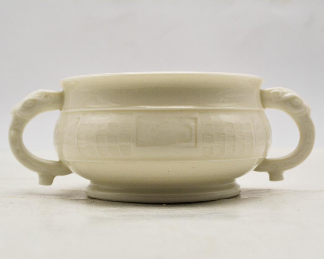 BLAMC-DE-CHINE INCENSE BURNER: The burner was created in DeHua Kiln. The burner's exterior is craved with stripe patterns. There are two dragon shaped handles. Normal Wear. H 2.67 in Mouth Diameter 4.64 in Bottom Diameter 3.62 in