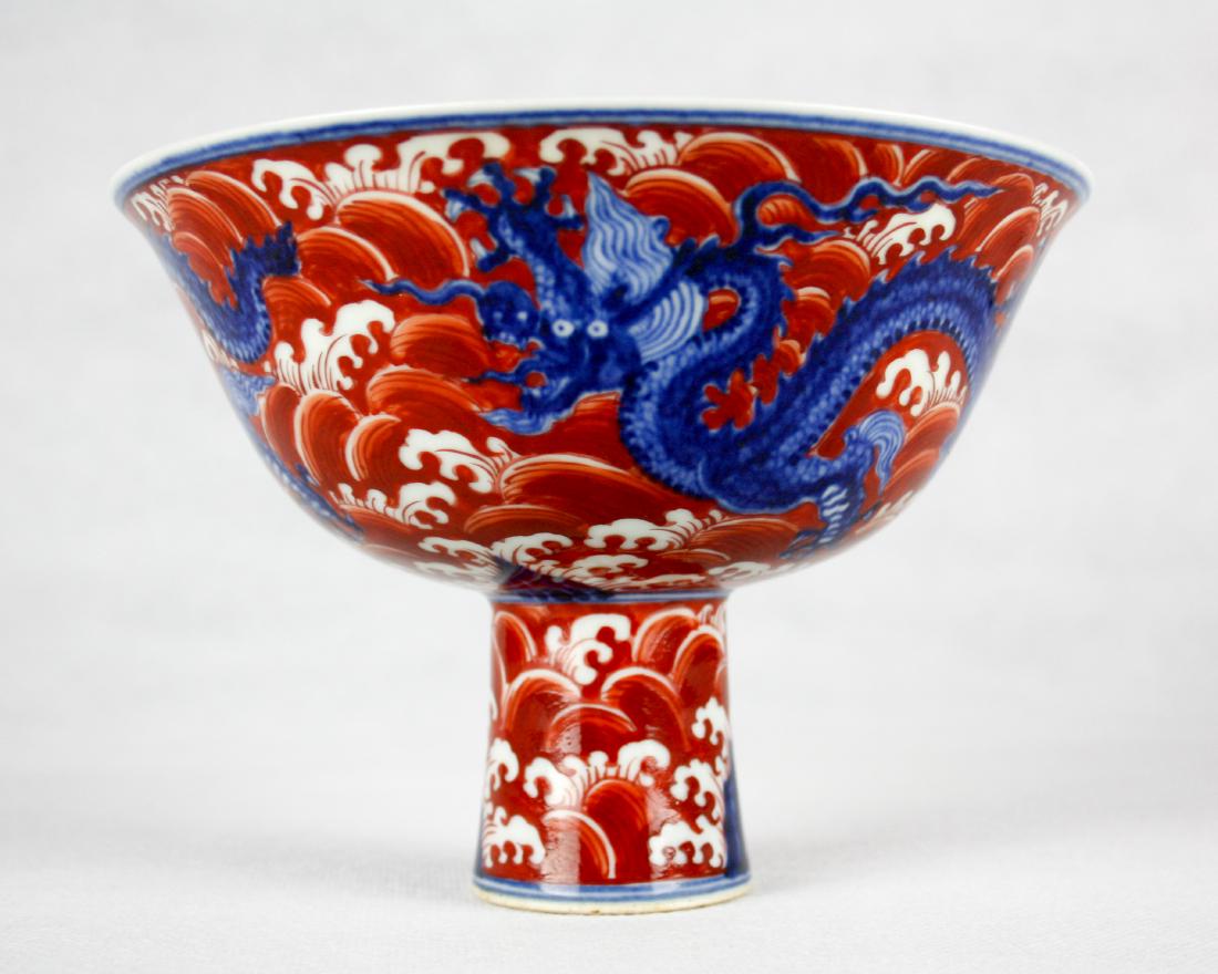DAMING XUANDE NIANZHI MARK STEAM BOWL: With DaMing XuanDe NianZhi Mark. An unusually iron-red-ground blue and white "an dragon and auspicious clouds' stembowl". Decorated on the exterior with a continuous sence of propitious clouds. Moreov
