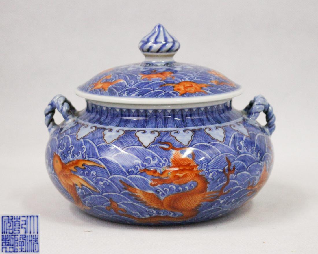 DAQING QIANLONG NIANZHI MARK BLUE&WHITE JAR: With DaQing QianLong NianZhi mark. The jar has two string shaped hanles on each side. The body and cover is decorated with dragons and waves. Height 5 in Diameter 6.10 in