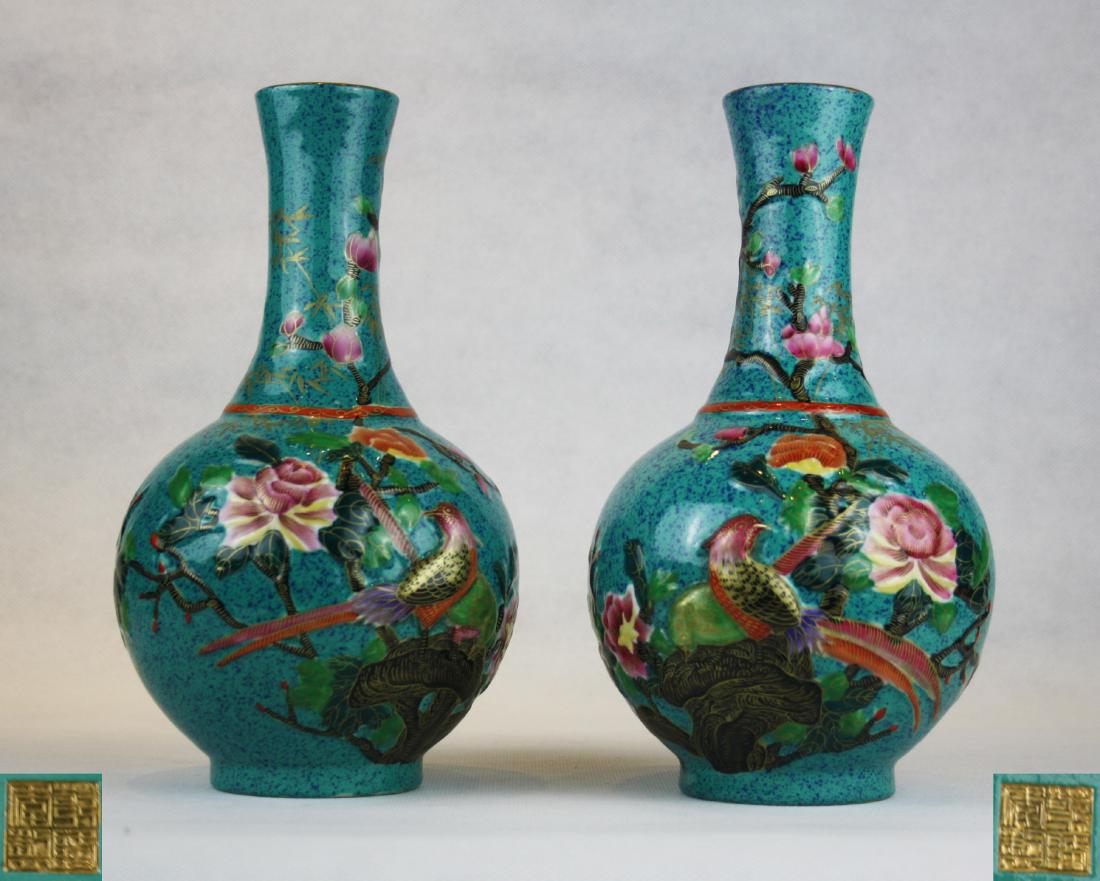 PAIR OF QIANLONG NIANZHI MARK ROBIN'S EGG GLAZED VASES: With QianLong NianZhi mark. Each robin's egg glazed vase is decorated with branch of blossoming flower and bird. H 8.85 in Mouth Diameter 1.85 in Bottom Diameter 2.55 in