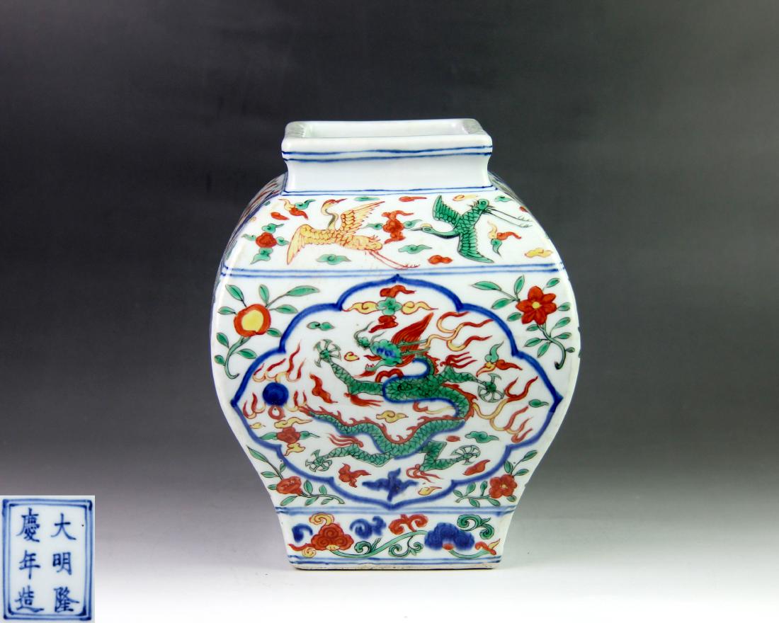 DAMING LONGQING NIANZAO MARK WUCAI VASE: With DaMing LongQing NianZao mark. The wucai vase is finely potted with a square mouth, which decorated with a double-circle line. The shoulder is painted with cranes amidst clouds in colors. The exte