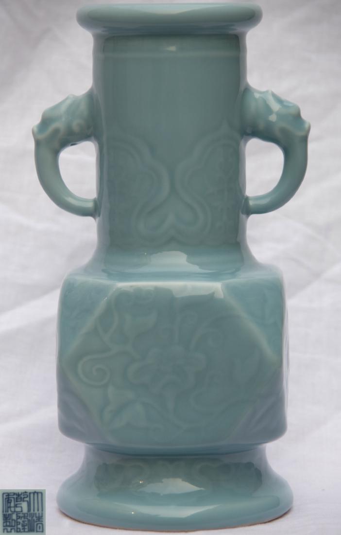 DAQING QIANLONG NIANZHI MARK CRAVED VASE: With DaQing QianLong NianZhi mark. The vase is finely covered with a glaze of color light green. The body is finely decorated with lotus scrolls. The neck has two monster head shaped handles. Height/L