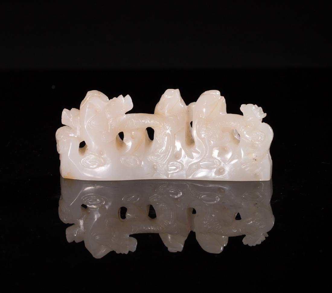 A HETIAN JADE OPENWORK DRAGON PEN HOLDER: Weight 204 g / Height 1.61 in / Wide 4.25 in / Thickness 1.1 in