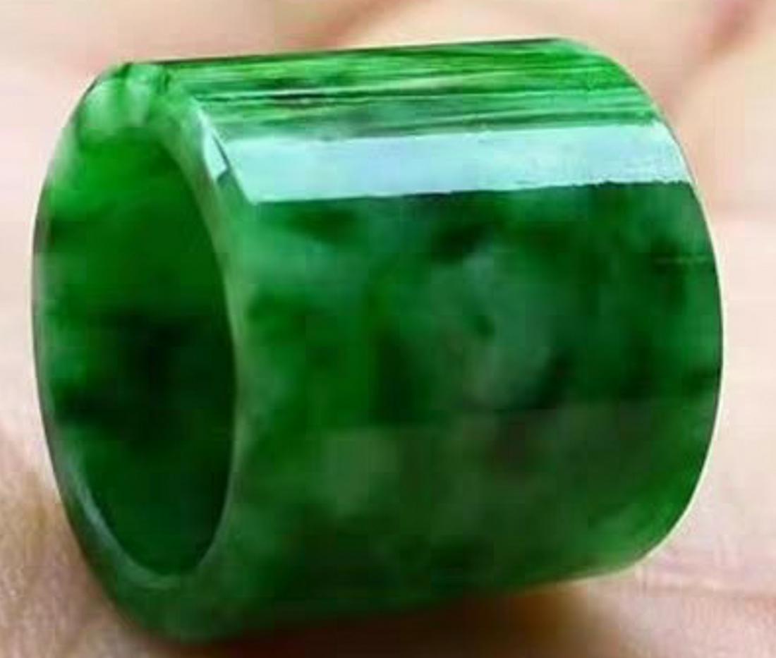 A JADEITE CARVED BANGLE: Size.
