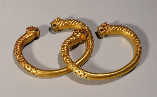 PAIR OF GILT BRONZE CAST BEAST BANGLES: Length 8.6 cm / Width 7 cm / Weight 215g