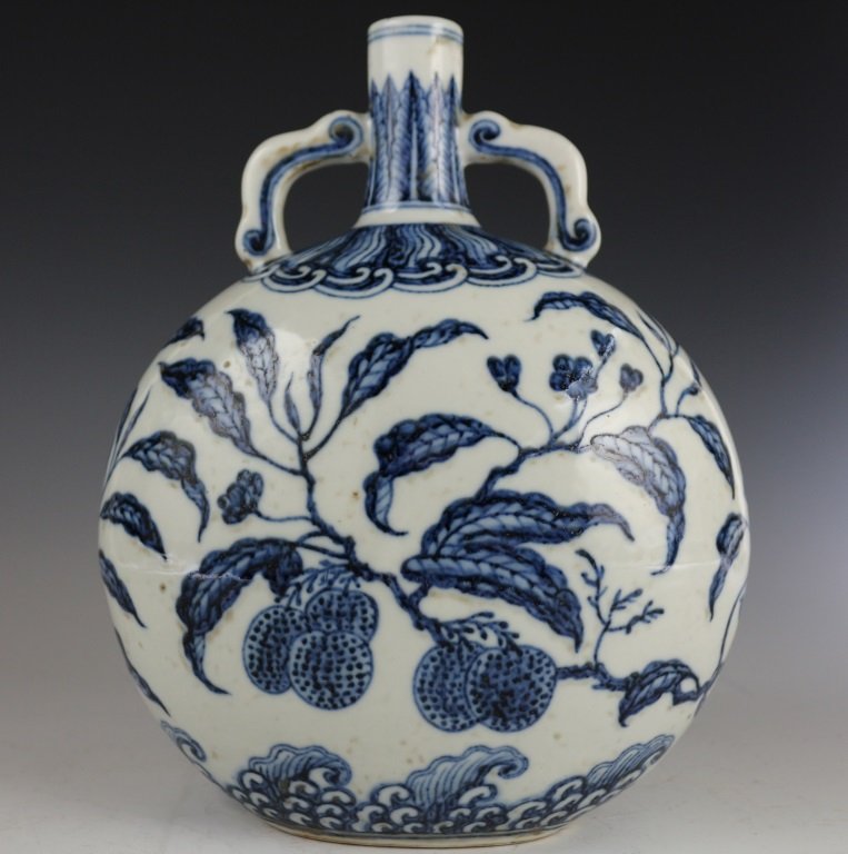 BLUE & WHITE MOON FLASK: The sturdily potted body is of flattened, circular shape with convex sides, and the slightly waisted neck is flanked by a pair of RuYi handles below the straight rim. The neck is decorated with the up