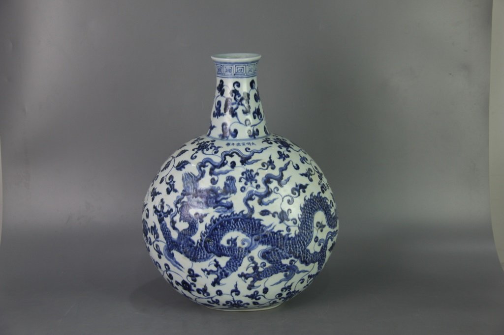 MING XUANDE MARK BLUE&WHITE FLAT VASE: Ming dynasty. With DaMing XuanDe NianZhi mark. The flat vase is finely painted with a band of key-fret boarder on the rim and dragon amidst flower design on the exterior. Dimension 45.5 cm x 36 cm x 8