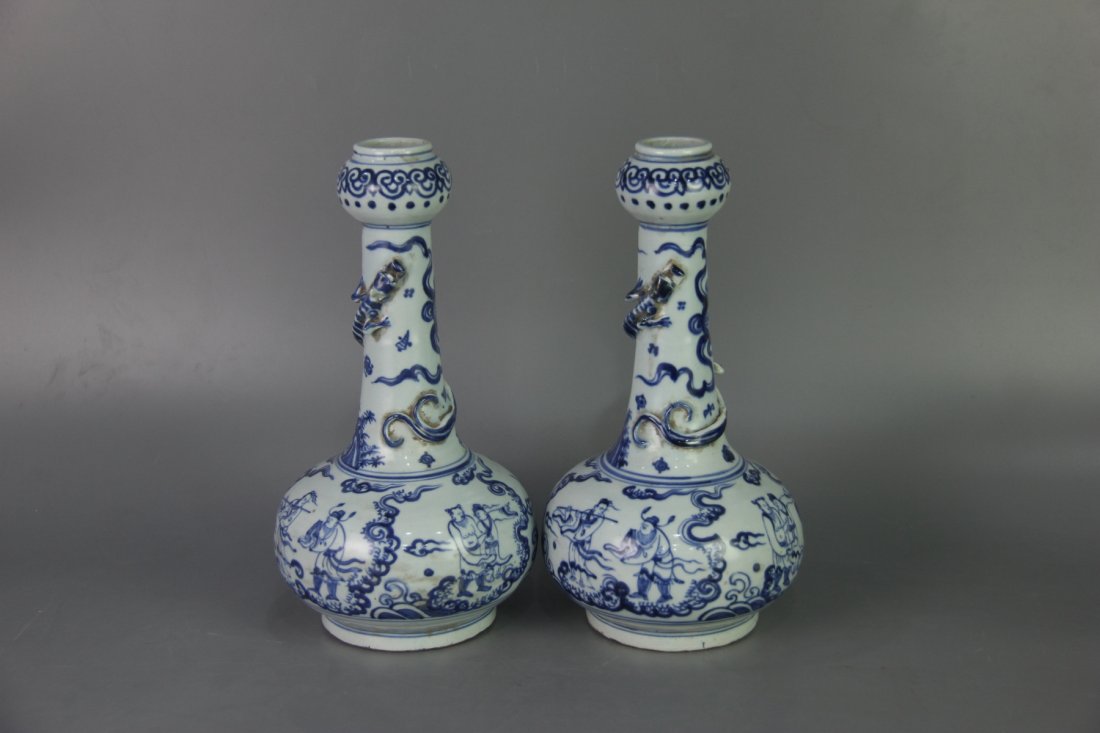 PAIR OF MING BLUE&WHITE GARLIC HEAD VASES: Ming dynasty. Each vase is potted with a compressed globular body, long neck rising to a garlic head mouth. The exterior is painted with the Eight Immortals, RuYi band and a dragon around the neck des