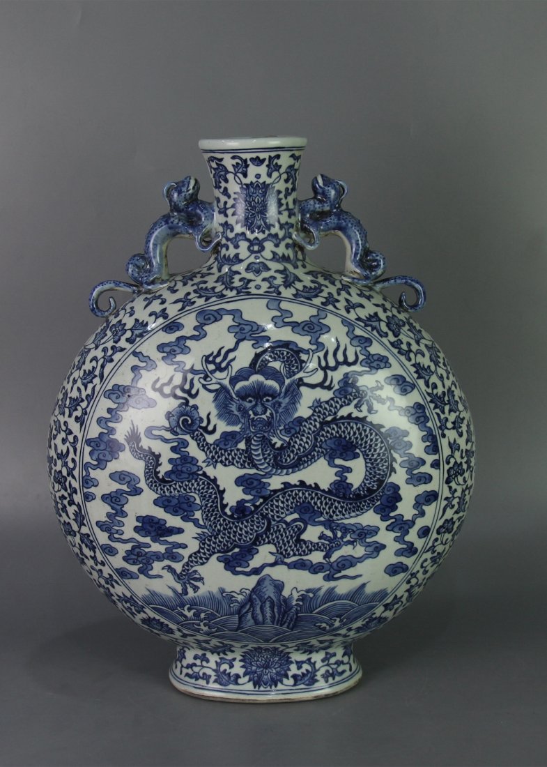 QING QIANLONG MARK BLUE&WHITE MOON-FLASK VASE: Qing dynasty. With DaQing QianLong NianZhi mark. The moon-flask body is painted with dragon amidst cloud and fire upon wave. Pair of beast shaped handles flank the shoulder. The exterior is decorated 