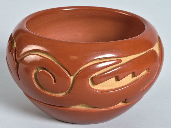 Teresita Naranjo, Santa Clara: Redware Pottery, c.1970-80 An elegant redware bowl highly polished, deeply carved with a duplication of the Avanyu. Signed "Teresita Naranjo Santa Clara Pueblo" 3 1/4 by 6 1/4 by 6 1/4 inches