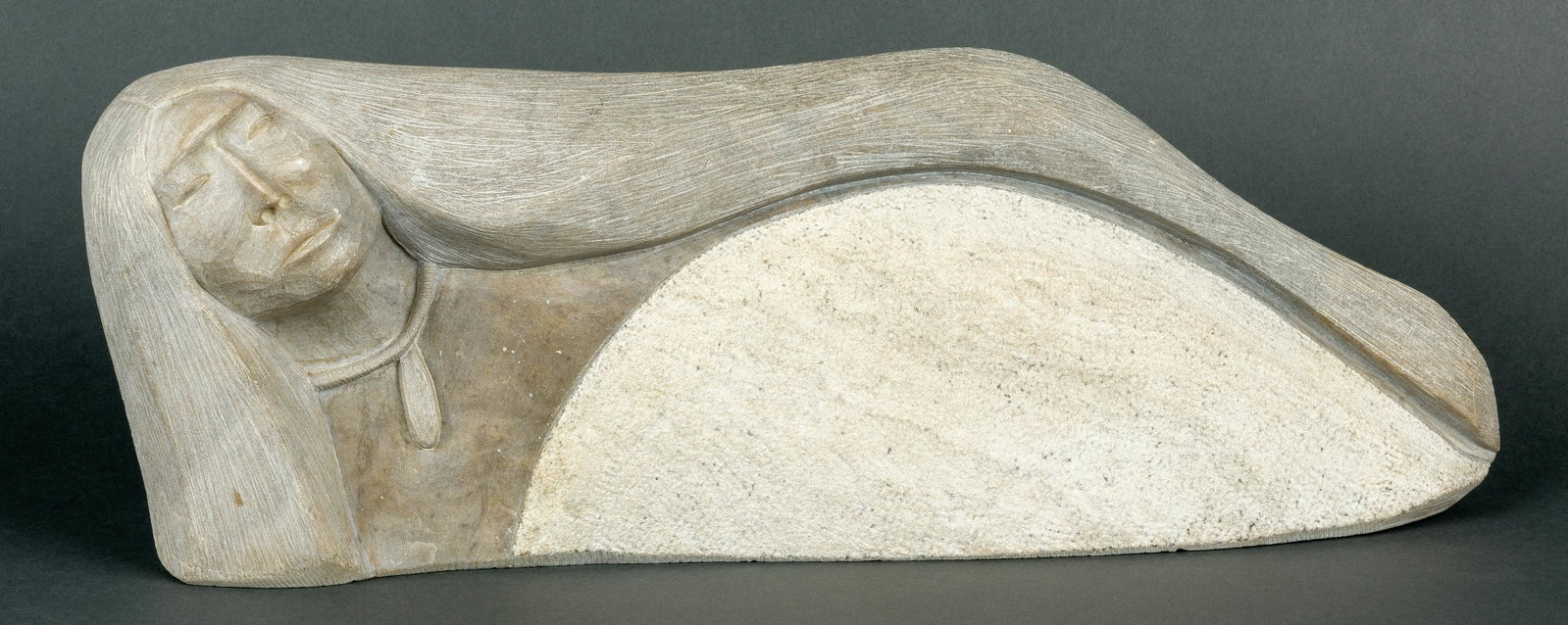 Clifford Fragua | Reclining Maiden: Artist: Clifford Fragua | 20th C. Title: Reclining Maiden Inscribed on rear: C. Fragua '84 Media: Stone Dimensions: 6 1/2 by 18 by 4 inches Condition: Very Good Condition Details: This sculpture is in