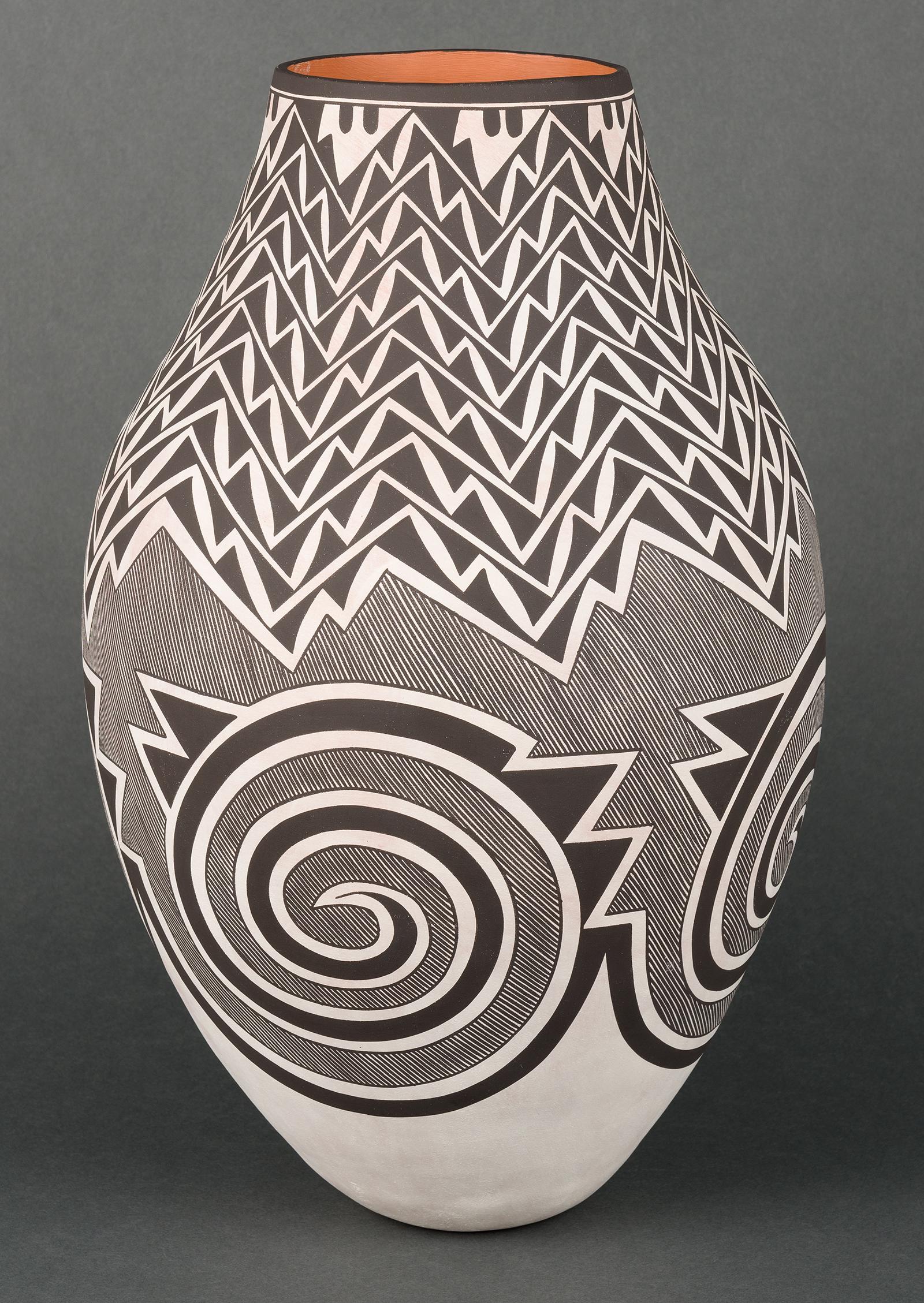 Myron Sarracino | Laguna Tall Pot with Prehistoric: Artist: Myron Sarracino | b. 1967 Title: Laguna Tall Pot with Prehistoric Design Signed on underside: M. Sarracino of Laguna, Pueblo Media: Clay Dimensions: 16 by 9 by 9 inches Condition: Very Good Co