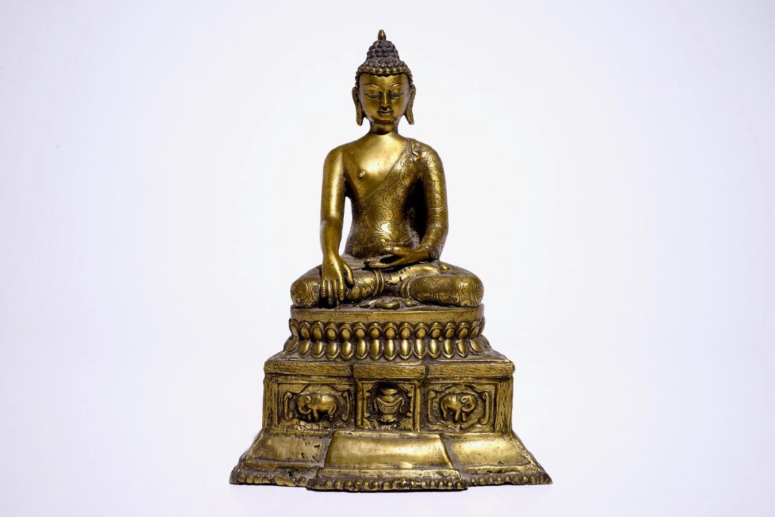 A gilt bronze model of Buddha seated on a throne, Nepal (1 of 8)