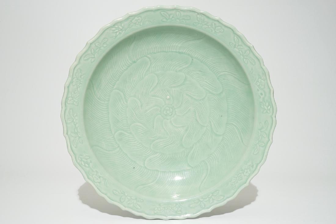 A Chinese monochrome celadon charger with underglaze: A Chinese monochrome celadon charger with underglaze floral design, Qianlong Dia.: 40 cm