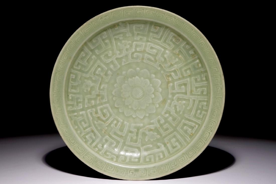 A Chinese celadon dish with incised lotus design, 19th (1 of 2)