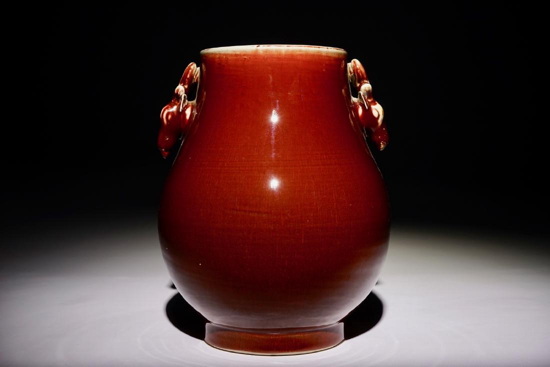 A Chinese monochrome sang-de-boeuf-glazed deer-handled: A Chinese monochrome sang-de-boeuf-glazed deer-handled hu vase, 19th C. H.: 31 cm