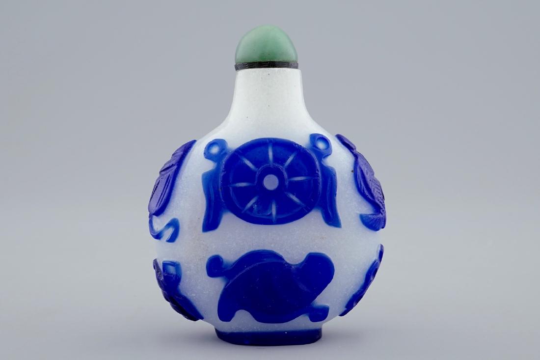 A Chinese blue and white overlay glass snuff bottle, (1 of 7)