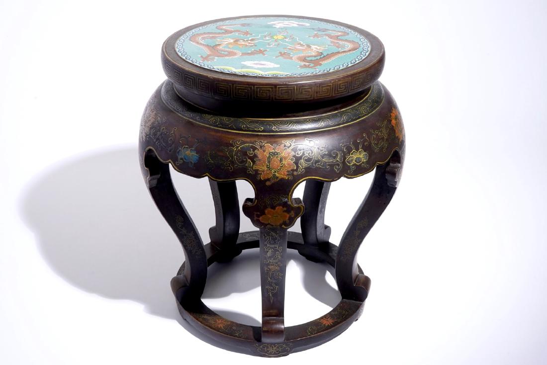 A Chinese lacquered wood and cloisonne stand, 20th C.: A Chinese lacquered wood and cloisonne stand, 20th C. Dia.: 48 cm - H.: 52,5 cm