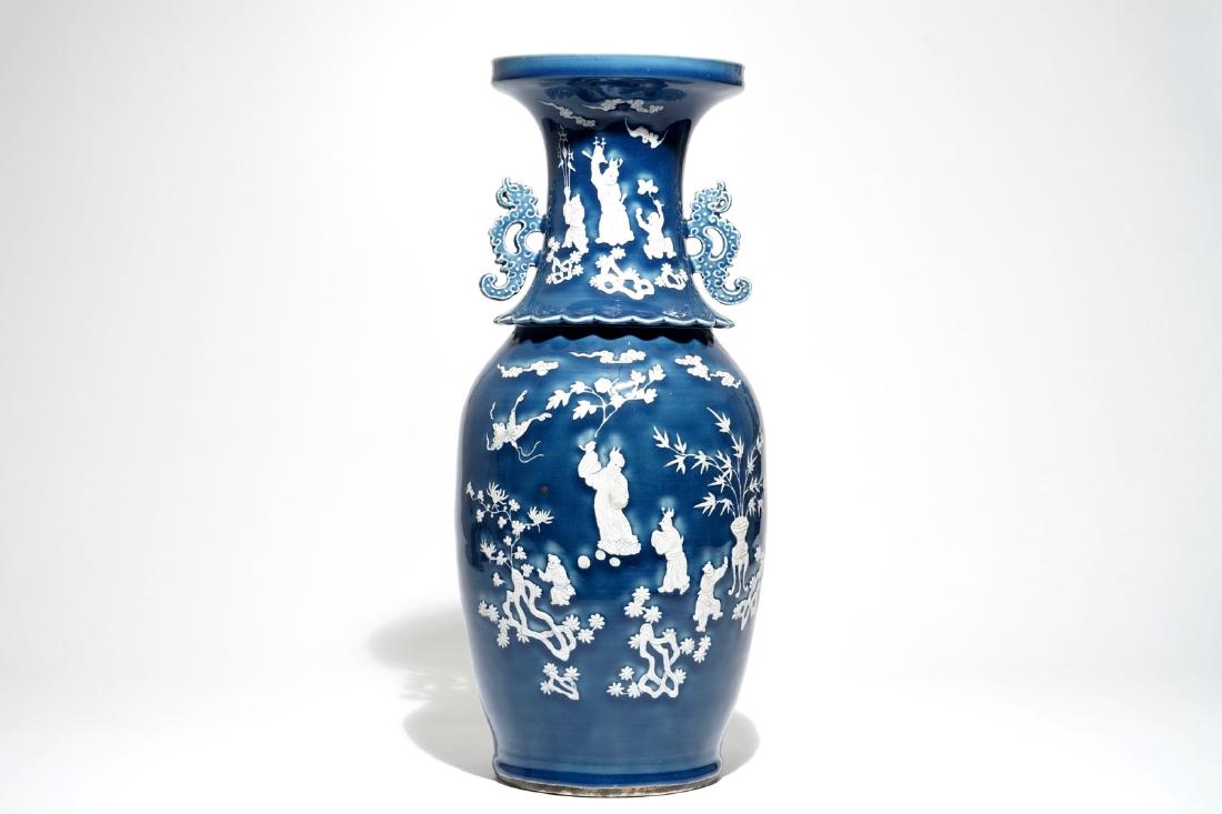 A tall Chinese blue-ground vase with applied white: A tall Chinese blue-ground vase with applied white design, 19th C. H.: 60 cm