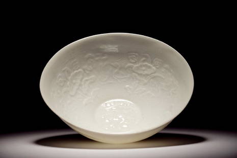 A Chinese monochrome white eggshell anhua bowl with: A Chinese monochrome white eggshell anhua bowl with applied design, Yongzheng mark, 19/20th C. H.: 4,5 cm - Dia.: 11 cm