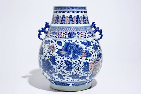 A Chinese copper-red and underglaze blue peony scroll: A Chinese copper-red and underglaze blue peony scroll hu vase, Qianlong mark, 19th C. H.: 45,5 cm