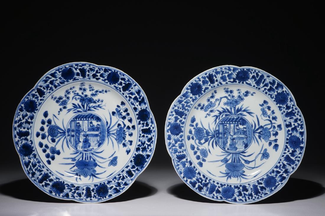 A pair of Chinese blue and white plates with figural: A pair of Chinese blue and white plates with figural medallions, Kangxi Dia.: 22 cm