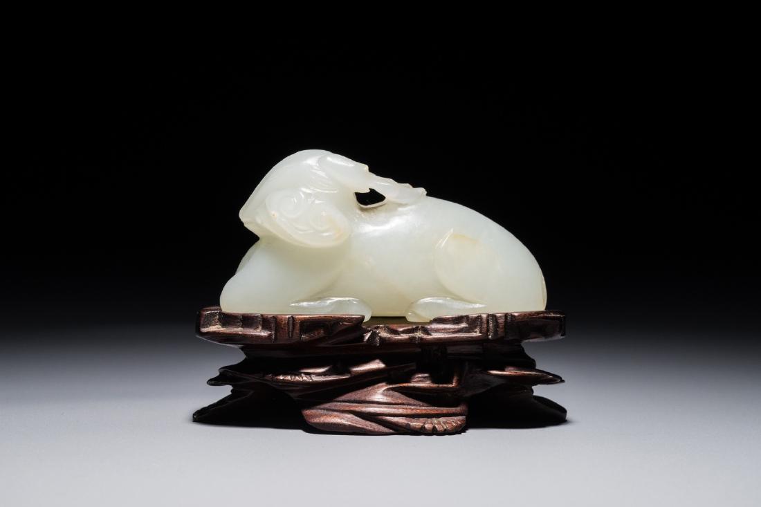 A Chinese jade carving of a ram on wooden base, 19th C. (1 of 8)