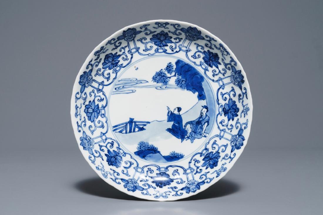 A Chinese blue and white moulded plate with figures in: A Chinese blue and white moulded plate with figures in a landscape, Kangxi mark and of the period Dia.: 20 cm