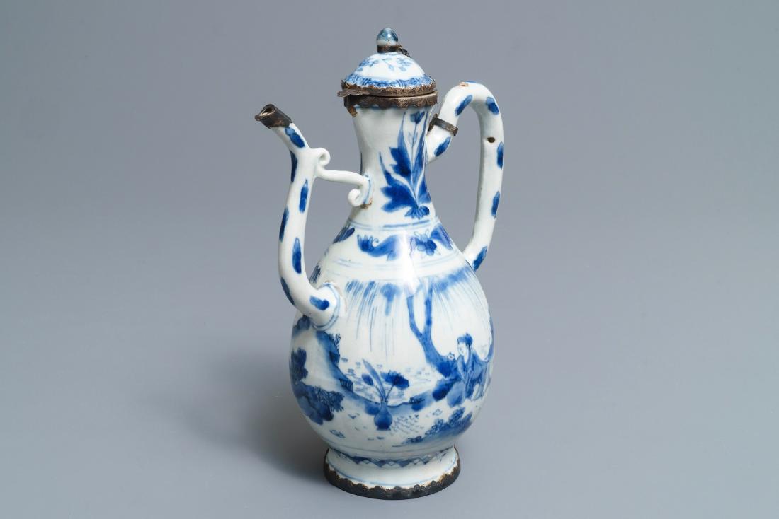 A Chinese blue and white silver-mounted jug and cover,: A Chinese blue and white silver-mounted jug and cover, Transitional period H.: 23,5 cm L.: 16,5 cm The associated silver-mounted cover dating to the Qianlong period. --------- Please request conditi