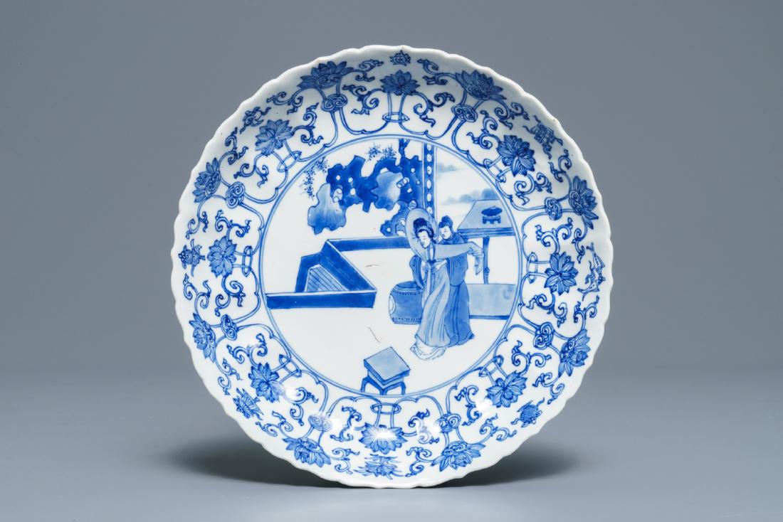 A Chinese blue and white moulded plate with figures on: A Chinese blue and white moulded plate with figures on a terrace, Kangxi mark and of the period Dia.: 20 cm --------- Please request condition reports by e-mail on info@rm-auctions.com or by using the