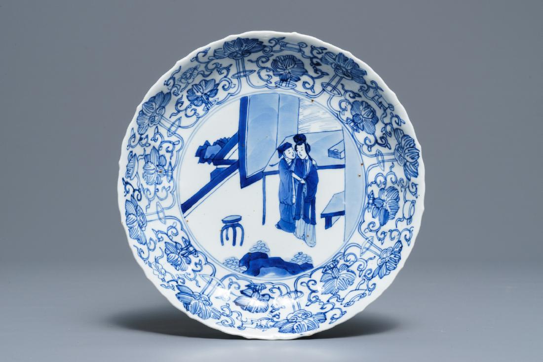 A Chinese blue and white moulded plate with an amorous: A Chinese blue and white moulded plate with an amorous couple, Kangxi mark and of the period Dia.: 20 cm --------- Please request condition reports by e-mail on info@rm-auctions.com or by using the Li