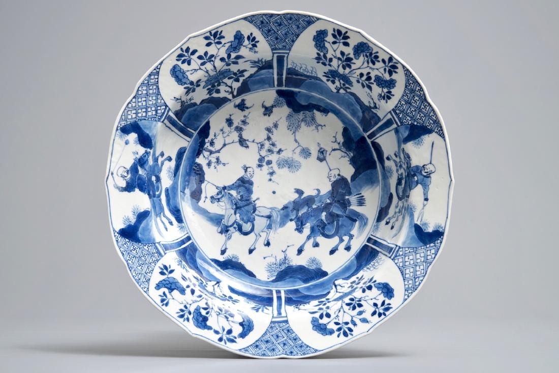 A Chinese blue and white 'horserider' dish, Kangxi mark (1 of 6)
